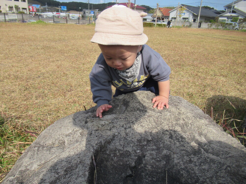 石に登ろうとする男の子