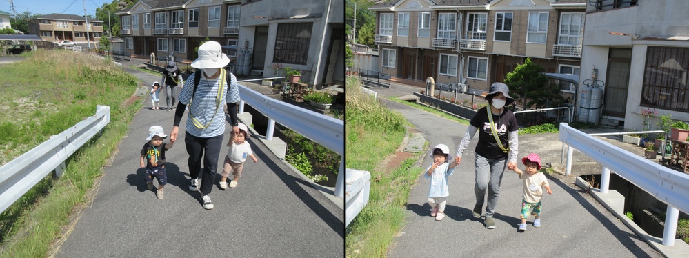 保育者と手をつないで歩いている