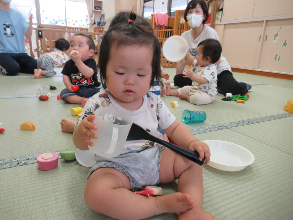 女の子がしゃもじを持って料理をしている２