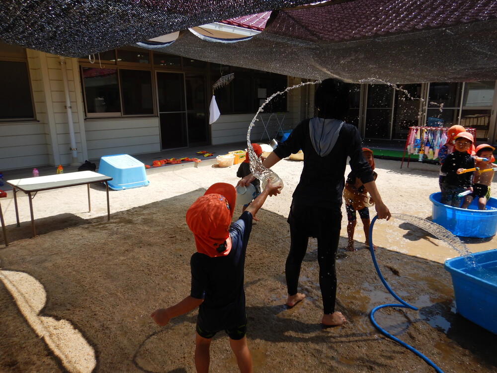 水のかけ合いをするお友だち