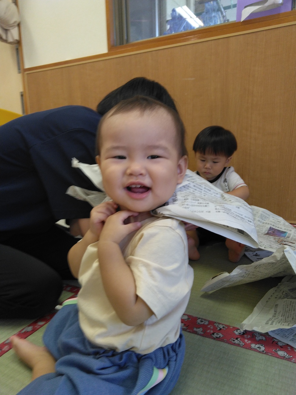新聞紙で遊ぶ子ども⑴